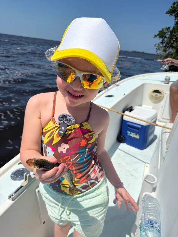 Aspen smiling on a family fishing adventure