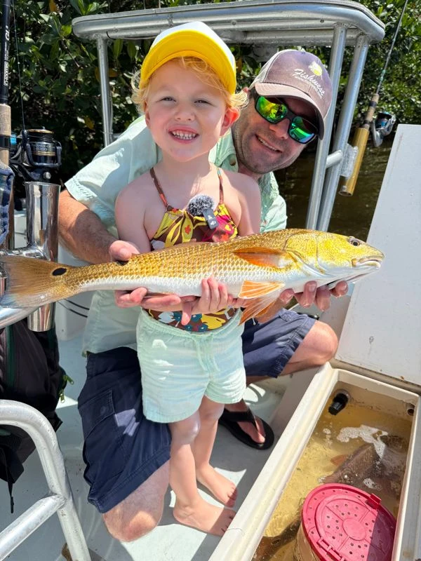 Aspen and her family sharing a catch on the boat
